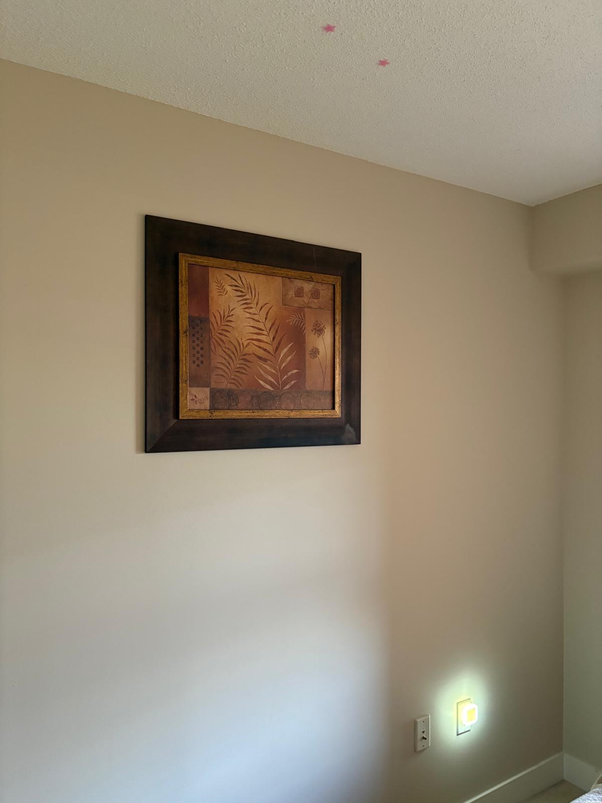 Framed art hung on wall
